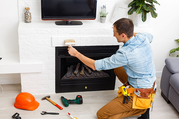 Man Repairing Fireplace in Living Room with Tools Nearby