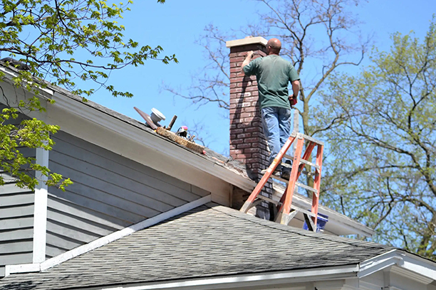 Worker on Ladder Performing Chimney Repair Warwick RI