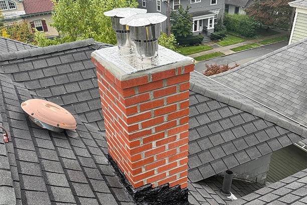 Brick Chimney with Metal Caps on Residential Roof, Chimney Repair Warwick RI